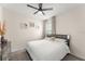 Bedroom with a black ceiling fan, neutral walls, and a large sunny window at 3866 Cabo Rojo Dr, St Cloud, FL 34772
