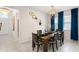 Inviting dining area with a wooden table, stylish light fixture and ample seating for gatherings at 3866 Cabo Rojo Dr, St Cloud, FL 34772