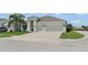 Well-maintained single-Gathering home featuring a spacious driveway leading to a two-car garage, surrounded by green lawns at 3866 Cabo Rojo Dr, St Cloud, FL 34772