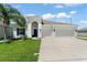 Inviting single Gathering home featuring a well-manicured lawn, two car garage and a charming arched entrance at 3866 Cabo Rojo Dr, St Cloud, FL 34772