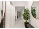 Bright hallway with tile flooring, decorative plant and mirror leading to other areas of the home at 3866 Cabo Rojo Dr, St Cloud, FL 34772