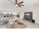 Open concept living room and kitchen with tile floors and a large ceiling fan at 3866 Cabo Rojo Dr, St Cloud, FL 34772