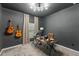 Stylish office with dark walls, modern light fixture and desk, and guitars for creative inspiration at 3866 Cabo Rojo Dr, St Cloud, FL 34772