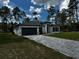 Lovely one-story home featuring a gray driveway, black trim, and a well-kept lawn at 5119 Sw 165Th Pl, Ocala, FL 34473