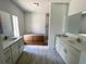 Bathroom with double vanities, granite countertops, and tiled floor at 5381 Sw 128Th Street Rd, Ocala, FL 34473