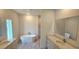 Luxurious bathroom featuring a soaking tub, dual vanities, granite counters, and tiled shower at 5381 Sw 128Th Street Rd, Ocala, FL 34473