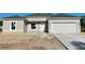Newly constructed home with a neutral facade, two-car garage, and a clean, modern aesthetic at 5381 Sw 128Th Street Rd, Ocala, FL 34473