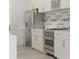 Modern kitchen with stainless steel appliances and stylish backsplash at 5381 Sw 128Th Street Rd, Ocala, FL 34473