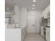 Open concept kitchen with white cabinetry, stainless appliances, and modern fixtures at 5381 Sw 128Th Street Rd, Ocala, FL 34473