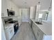 Bright kitchen with white cabinets, quartz counters, and stainless steel appliances at 5381 Sw 128Th Street Rd, Ocala, FL 34473