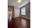 Bedroom with a closet, window, and hardwood floors at 6434 Cava Alta Dr # 401, Orlando, FL 32835