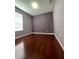 Bedroom with hardwood floors, window, and neutral colored walls at 6434 Cava Alta Dr # 401, Orlando, FL 32835