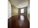 Comfortable bedroom with hardwood floors and window with blinds at 6434 Cava Alta Dr # 401, Orlando, FL 32835
