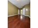 Clean, empty bedroom showcasing hardwood floors and a closet at 6434 Cava Alta Dr # 401, Orlando, FL 32835