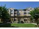 Exterior building shot showing manicured landscaping and pergola at 6434 Cava Alta Dr # 401, Orlando, FL 32835