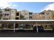 Apartment building with multiple stories and covered parking at 6434 Cava Alta Dr # 401, Orlando, FL 32835
