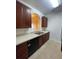 Kitchen featuring stainless steel sink, dark cabinets, and tiled floor at 6434 Cava Alta Dr # 401, Orlando, FL 32835