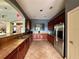 Spacious kitchen featuring stainless steel refrigerator, granite countertops, and ample cabinet space at 6434 Cava Alta Dr # 401, Orlando, FL 32835