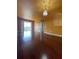 Spacious living room featuring hardwood floors and stylish chandelier at 6434 Cava Alta Dr # 401, Orlando, FL 32835