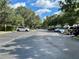 Residents parking lot with marked parking spaces and lush trees at 6434 Cava Alta Dr # 401, Orlando, FL 32835