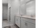 Modern bathroom with double sinks, white cabinets, and a glass-enclosed shower at 6458 Pine Warbler Way, St Cloud, FL 34771