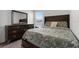 Comfortable bedroom with a large dresser, matching nightstand, and a window offering natural light at 6458 Pine Warbler Way, St Cloud, FL 34771