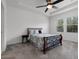Inviting bedroom with tray ceiling, ceiling fan, and serene view from bright windows at 6458 Pine Warbler Way, St Cloud, FL 34771