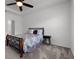 Comfortable bedroom showcasing neutral carpet, a ceiling fan and simple decor at 6458 Pine Warbler Way, St Cloud, FL 34771