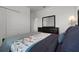 Bedroom showing a gray comforter, mirrored dresser, and neutral carpeting at 6458 Pine Warbler Way, St Cloud, FL 34771