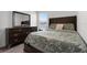 Comfortable bedroom with a large dresser, matching nightstand, and a window offering natural light at 6458 Pine Warbler Way, St Cloud, FL 34771