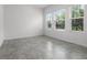 Bright and airy bedroom with tile floors and ample natural light from large windows at 6458 Pine Warbler Way, St Cloud, FL 34771