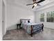 Inviting bedroom with tray ceiling, ceiling fan, and serene view from bright windows at 6458 Pine Warbler Way, St Cloud, FL 34771