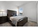 Cozy bedroom showcasing neutral carpet, a window, nightstand and a lamp at 6458 Pine Warbler Way, St Cloud, FL 34771