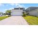 Beautiful two-story home with a spacious driveway and a well-manicured lawn at 6458 Pine Warbler Way, St Cloud, FL 34771