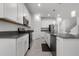 Stylish kitchen featuring white cabinetry, stainless steel appliances and a convenient island at 6458 Pine Warbler Way, St Cloud, FL 34771