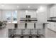 Modern kitchen with white cabinets, stainless steel appliances, and bar seating at the island at 6458 Pine Warbler Way, St Cloud, FL 34771