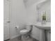 Clean half bathroom with pedestal sink, mirror and tile floors at 6458 Pine Warbler Way, St Cloud, FL 34771