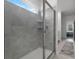 Tiled walk-in shower with glass door and convenient built-in shelving at 6458 Pine Warbler Way, St Cloud, FL 34771
