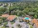 A bird's-eye view of Hidden Springs showcasing buildings, pool and spa, parking, landscaping, and neighboring trees at 698 Roaring Dr # 382, Altamonte Springs, FL 32714