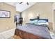 Well-lit bedroom showcasing a desk and computer setup, complemented by a cozy ceiling fan at 698 Roaring Dr # 382, Altamonte Springs, FL 32714