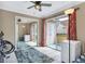 Bright bedroom with sliding glass doors, mirrored closet, ceiling fan, and neutral walls and tile at 698 Roaring Dr # 382, Altamonte Springs, FL 32714