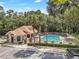Overhead view of the community pool, clubhouse, and amenities at Hidden Springs, surrounded by mature trees at 698 Roaring Dr # 382, Altamonte Springs, FL 32714