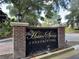 Welcome to Hidden Springs Condominiums: a distinguished community entrance with a decorative sign and brick surround at 698 Roaring Dr # 382, Altamonte Springs, FL 32714