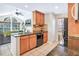 Well-appointed kitchen featuring granite counters, black appliances and views into the living room at 698 Roaring Dr # 382, Altamonte Springs, FL 32714