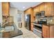 Efficient kitchen with stainless steel appliances, tiled backsplash, and ample cabinet space at 698 Roaring Dr # 382, Altamonte Springs, FL 32714