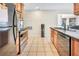 A view of the kitchen with stainless steel appliances and light wood cabinets at 698 Roaring Dr # 382, Altamonte Springs, FL 32714