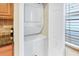 Convenient in-unit laundry featuring a stacked washer and dryer with nearby storage at 698 Roaring Dr # 382, Altamonte Springs, FL 32714