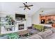 Inviting living room with fireplace, large screen TV, vaulted ceilings, and seamless flow to the kitchen at 698 Roaring Dr # 382, Altamonte Springs, FL 32714