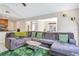 Open-concept living room with a large sectional sofa and seamless access to the breakfast nook at 698 Roaring Dr # 382, Altamonte Springs, FL 32714