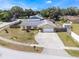 Aerial view of a well-maintained property with a fenced yard, mature trees, and a spacious driveway at 7750 Murcott Cir, Orlando, FL 32835